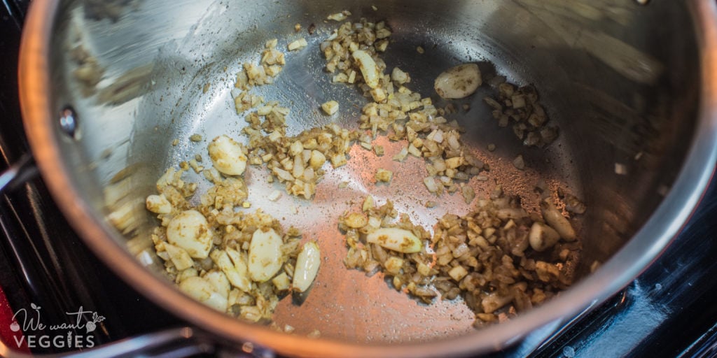 Add the garlic cloves & cumin.