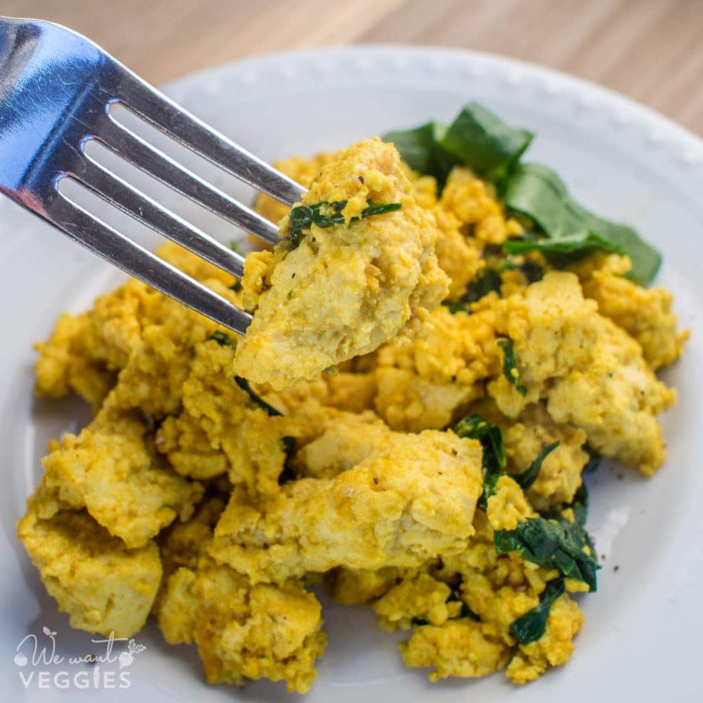 A fork digs into a tasty bowl of tofu scramble.