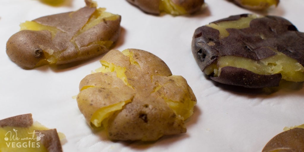 Smashed potatoes on parchment.