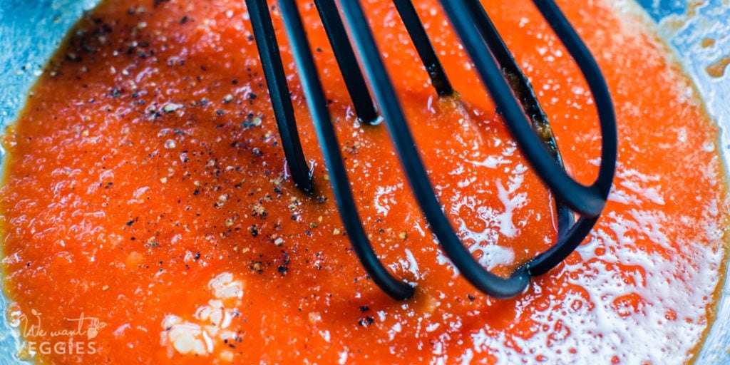 Sauce being whisked in a bowl.