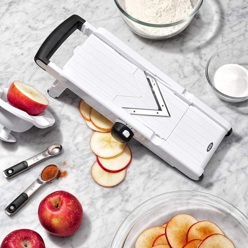 Slicer on counter with apples, slices, and cinnamon