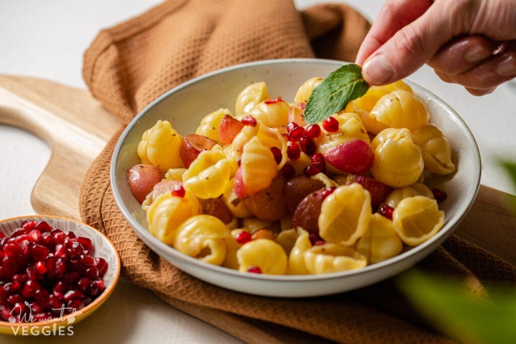 Placing mint leaf on pasta