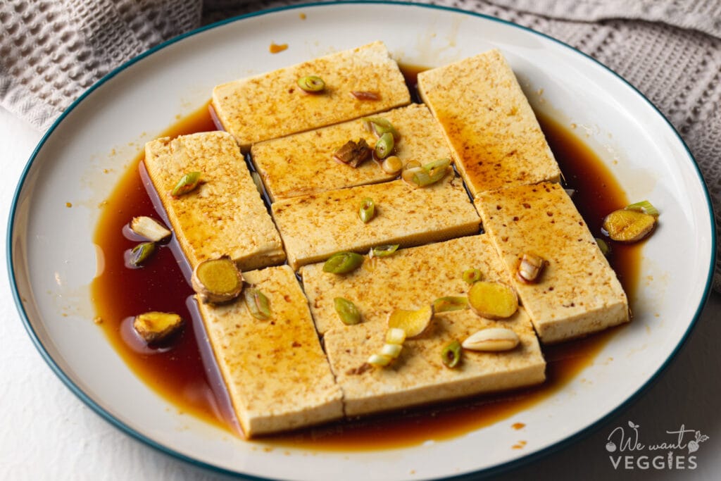 Tofu marinating in a dish