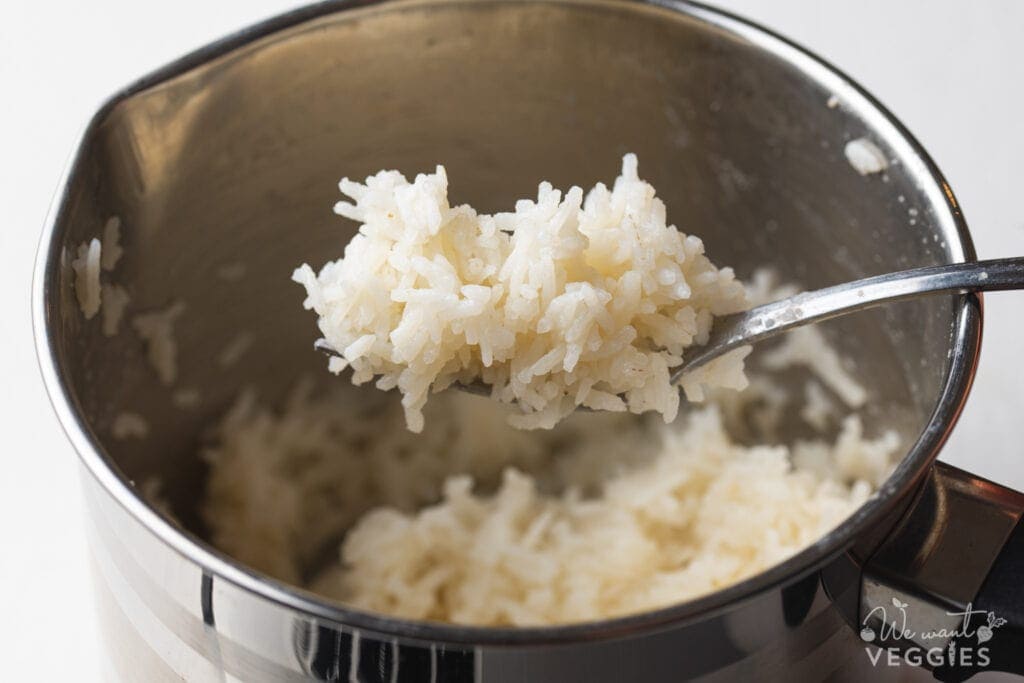 Prepared rice on fork over pot
