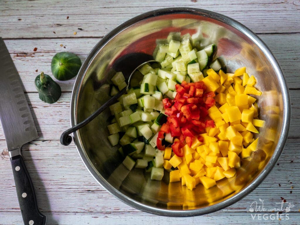Diced Cucumber Mango & Red Pepper In Bowl With Spoon