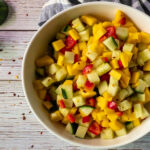 Mango cucumber salad in a bowl with spoon