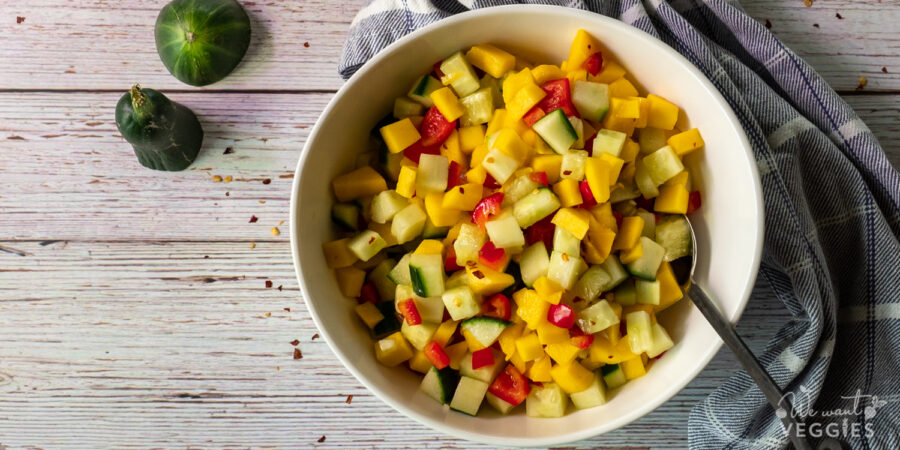 Mango cucumber salad in a bowl with spoon