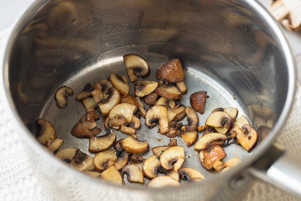Mushrooms cooking in sauce pan