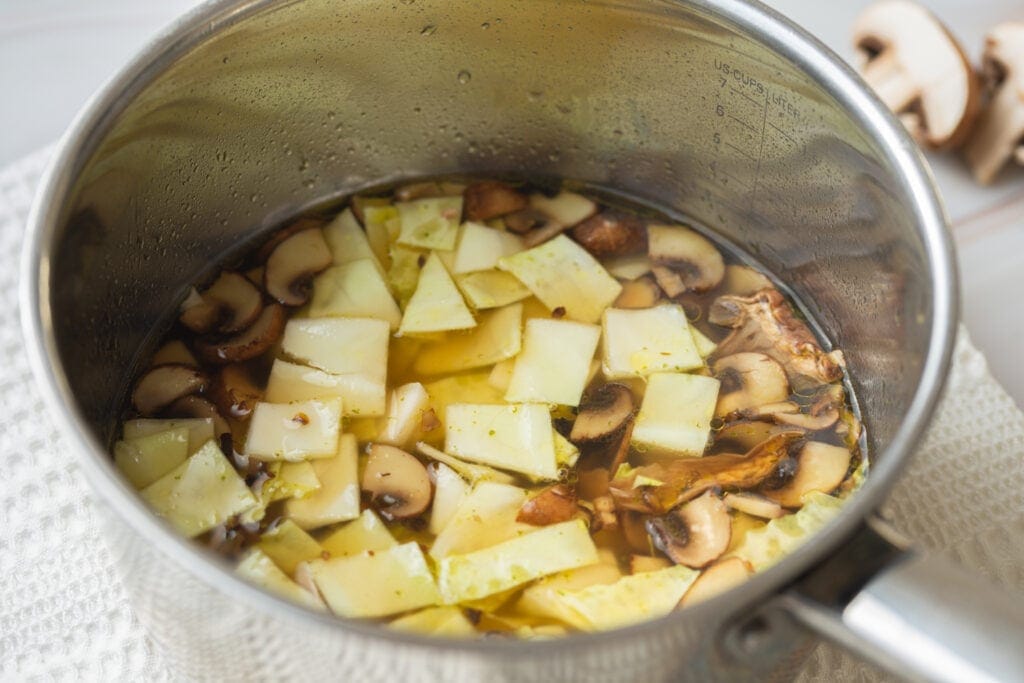 Chopped cabbage with mushrooms, miso and broth in pot