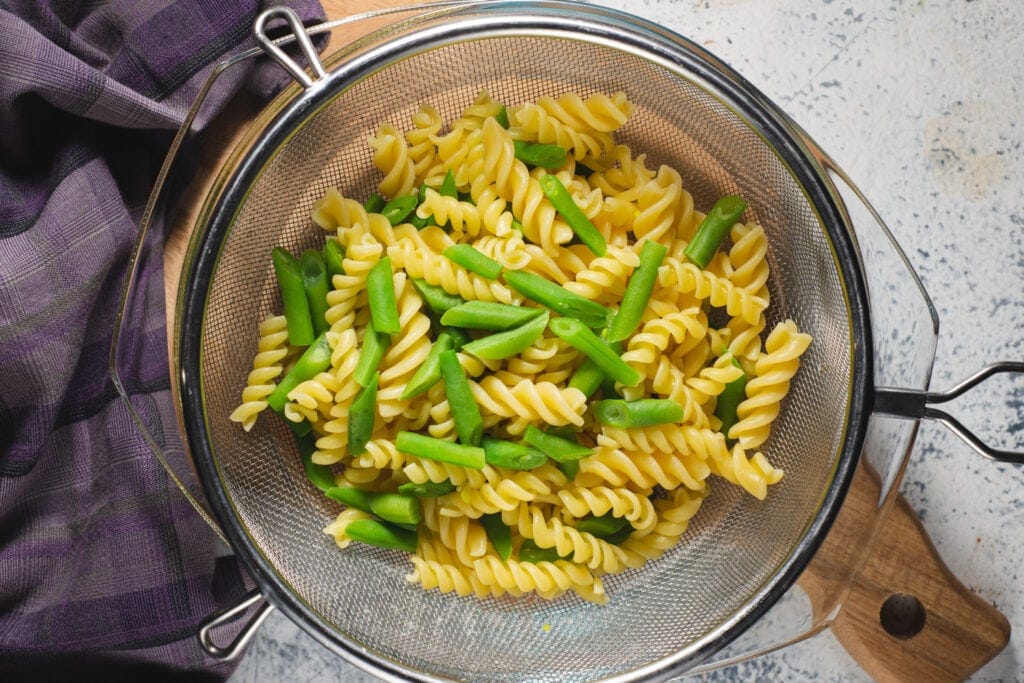 Fusilli and green beans in strainer