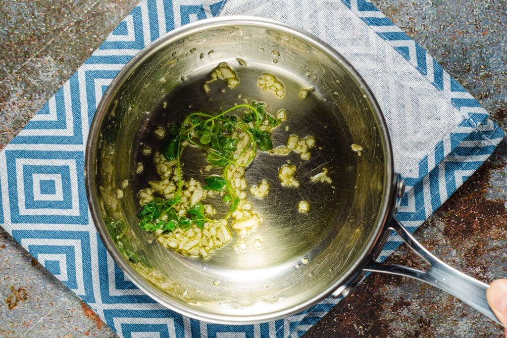 Garlic and thyme in pan with olive oil