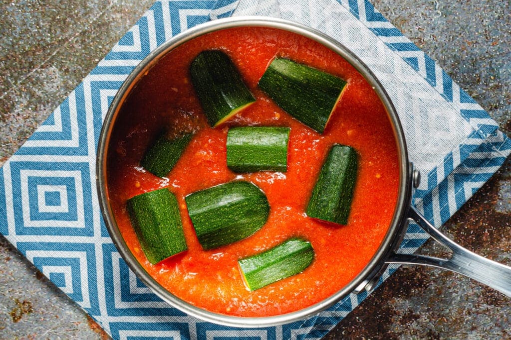 Zucchini placed in tomato sauce.