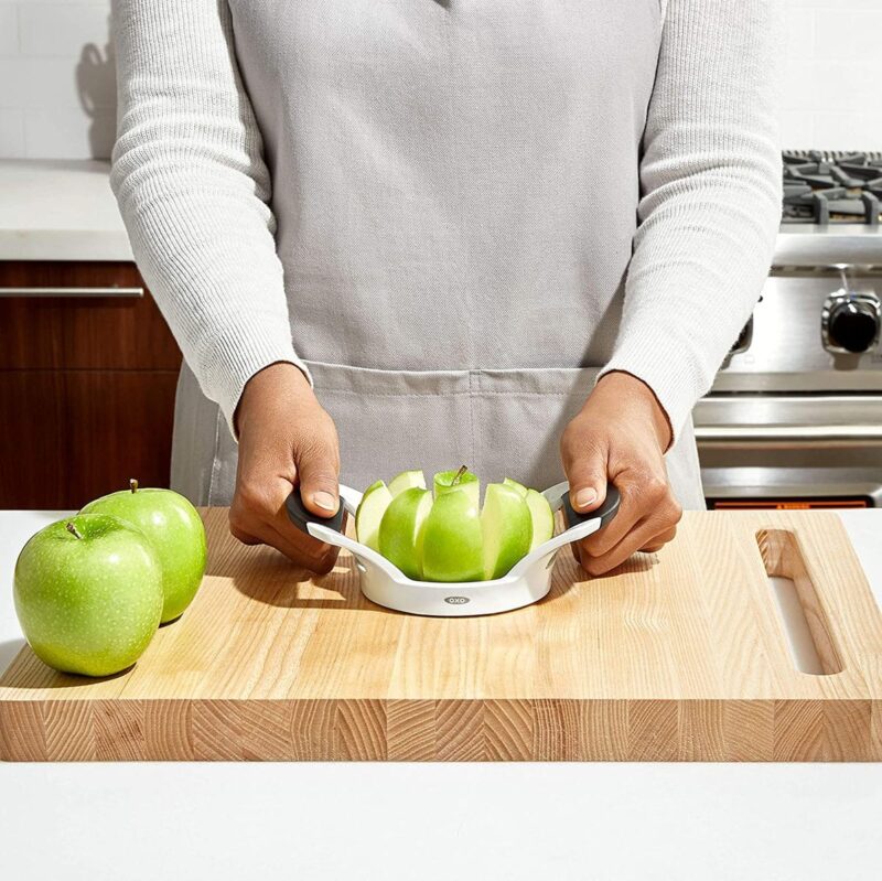 Person slicing apples with device
