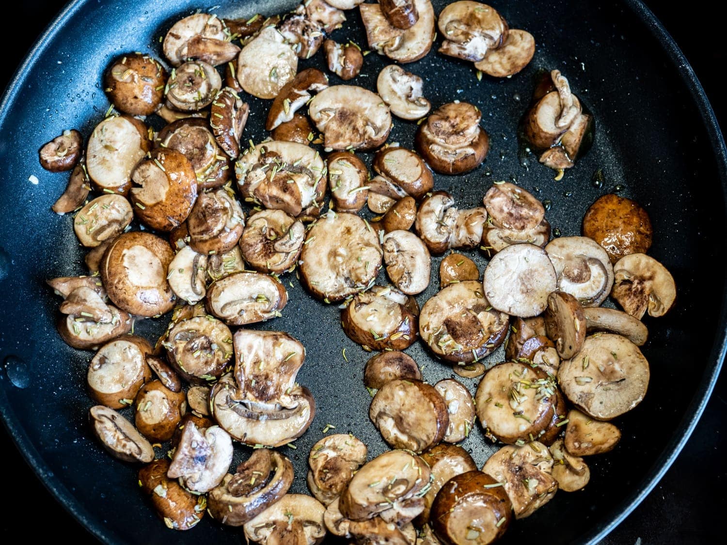 Mushrooms cooking in non-stick skillet