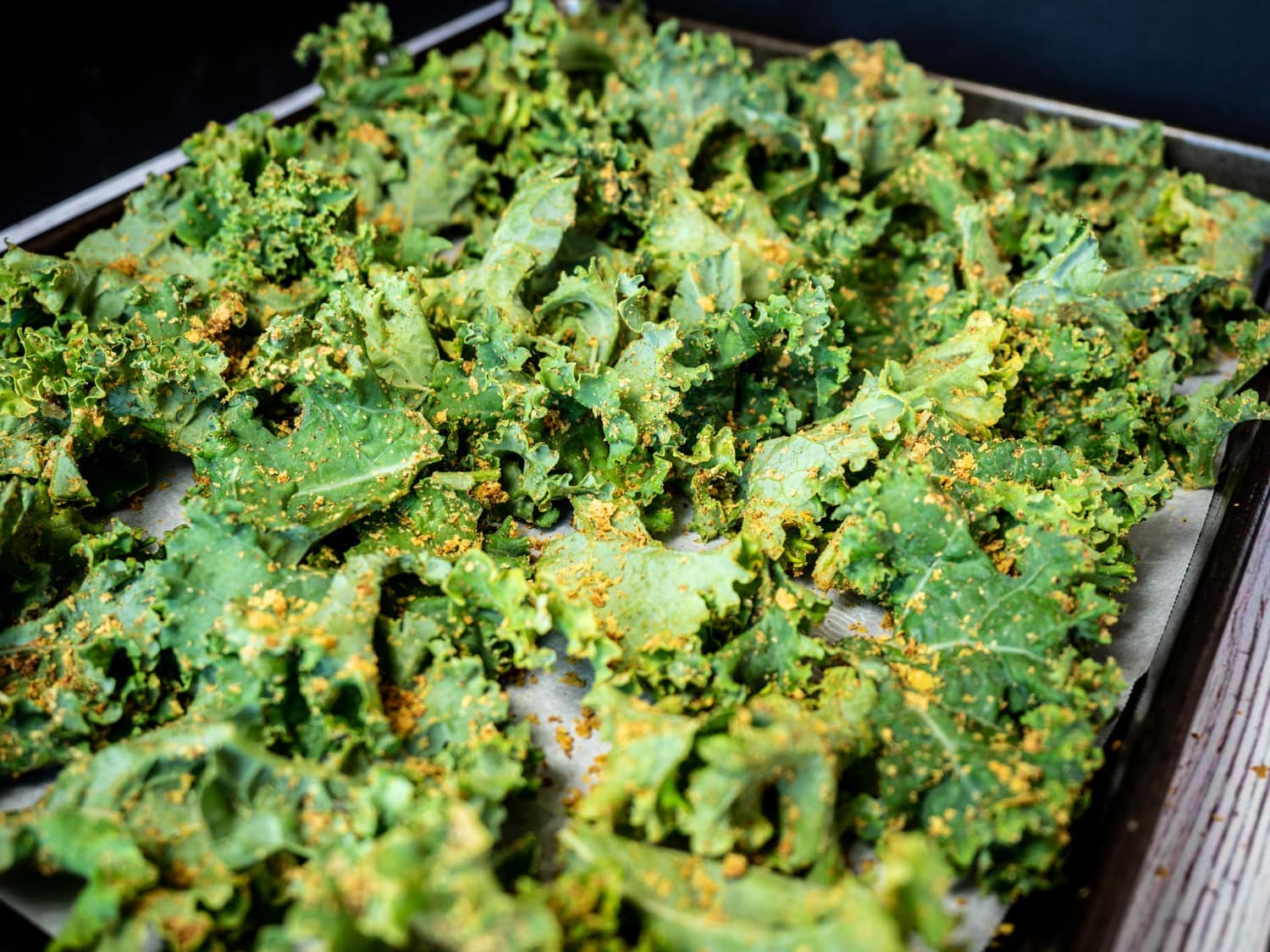 Seasoned kale on baking sheet