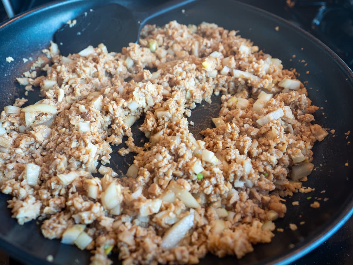 Mixture cooking in skillet.