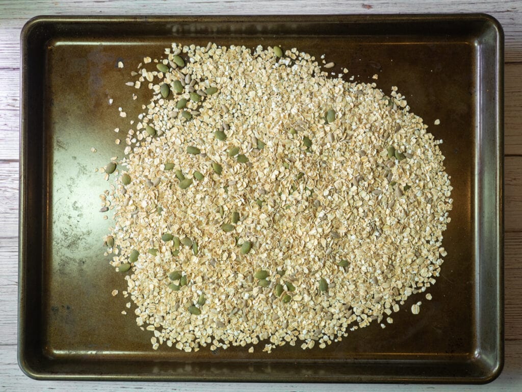 Oats and seeds on baking pan